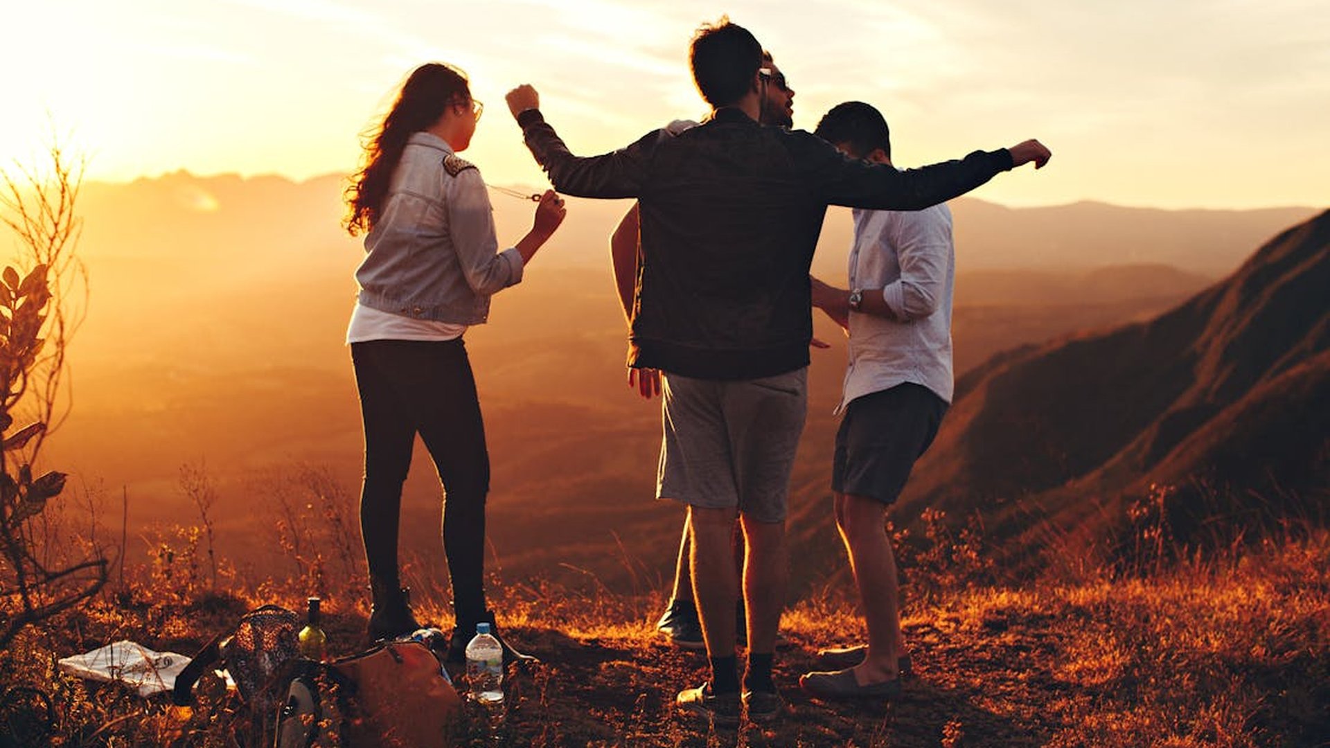 Friends enjoying a sunset viewpoint on a group trip